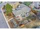 Aerial view of a landscaped home with a large patio, garden beds, mature trees, and an outdoor seating area at 2 N Jasmine St, Denver, CO 80220