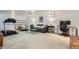 Finished basement area with comfortable seating, a desk, and workout equipment at 2 N Jasmine St, Denver, CO 80220