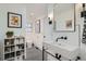 Stylish bathroom with geometric floor tiles, modern vanity, and artistic decor at 2 N Jasmine St, Denver, CO 80220