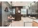Sleek bathroom featuring a modern design with black herringbone tiles and a glass-enclosed shower and tub at 2 N Jasmine St, Denver, CO 80220