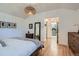 Bedroom with vaulted ceiling, walk in to bathroom, and hardwood floors at 2 N Jasmine St, Denver, CO 80220