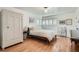 Bright bedroom with white shiplap walls, plantation shutters, and hardwood floors at 2 N Jasmine St, Denver, CO 80220