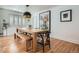 Bright dining room with light wood floor, neutral walls, and a large dining table at 2 N Jasmine St, Denver, CO 80220