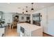 Bright, open kitchen with an island, modern appliances, and pendant lighting over the dining table at 2 N Jasmine St, Denver, CO 80220