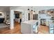 Open-concept kitchen with a large island, stainless steel appliances, and seamless flow to the living area at 2 N Jasmine St, Denver, CO 80220