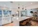 Modern kitchen featuring stainless steel appliances, a large island, and stylish lighting fixtures at 2 N Jasmine St, Denver, CO 80220