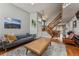 Comfortable living room featuring a sofa, leather chair, fireplace, area rug and hardwood floors at 12667 Meade St, Broomfield, CO 80020