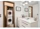 Well-lit bathroom with modern vanity, mirror and convenient access to a stacked washer and dryer at 780 Walnut St # A, Boulder, CO 80302