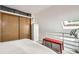 Bright bedroom featuring a skylight, built-in shelving, and sliding door closet for ample storage at 780 Walnut St # A, Boulder, CO 80302