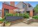 Charming exterior view of a multi-level home with gray siding, brick accents, and a garden area at 780 Walnut St # A, Boulder, CO 80302