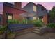 Charming exterior view of a multi-level home with gray siding, brick accents, and a garden area at 780 Walnut St # A, Boulder, CO 80302