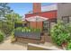 Inviting patio area with privacy planters, a large umbrella, and a brick exterior at 780 Walnut St # A, Boulder, CO 80302