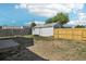 Good-sized backyard with a new wooden fence, a shed, and a small garden bed at 6691 Hooker St, Denver, CO 80221