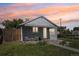 Charming single-story home with a covered front porch, green lawn, and blossoming plants adding curb appeal at 6691 Hooker St, Denver, CO 80221