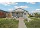 Charming single-story home with covered porch, landscaped front yard, walkway and great curb appeal at 6691 Hooker St, Denver, CO 80221