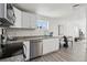Modern kitchen featuring stainless steel appliances, granite countertops, and ample natural light creating a bright atmosphere at 6691 Hooker St, Denver, CO 80221