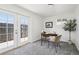 Cozy home office featuring gray carpet, a work desk, a plant and a doorway to the backyard area at 6691 Hooker St, Denver, CO 80221