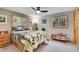 Relaxing bedroom with neutral tones, natural light, and windows offering views of the surrounding trees at 11182 S Barney Gulch Rd, Conifer, CO 80433