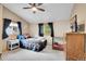 Charming bedroom with blue curtains, a patterned bedspread, and ample natural light at 11182 S Barney Gulch Rd, Conifer, CO 80433