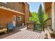 Spacious deck with access to the home, featuring an outdoor seating area and views of the surrounding greenery at 11182 S Barney Gulch Rd, Conifer, CO 80433