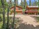 Exterior of a well-maintained home with a garage and lush natural surroundings at 11182 S Barney Gulch Rd, Conifer, CO 80433