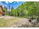 Expansive front yard with mature trees, firepit, and convenient access to the house and garage at 11182 S Barney Gulch Rd, Conifer, CO 80433