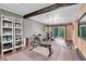 Home gym featuring wood-paneled walls, concrete walls, modern flooring, and various exercise equipment at 11182 S Barney Gulch Rd, Conifer, CO 80433