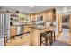 Well-lit kitchen featuring stainless steel appliances, granite countertops, and wooden cabinets at 11182 S Barney Gulch Rd, Conifer, CO 80433