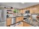Well-lit kitchen with granite countertops, stainless steel appliances, wood cabinets, and a view of the outdoors at 11182 S Barney Gulch Rd, Conifer, CO 80433
