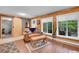 Charming living room with wood-paneled walls, modern flooring, plush seating, and a sliding barn door at 11182 S Barney Gulch Rd, Conifer, CO 80433