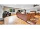 Bright living room with hardwood floors, comfortable seating, and large windows with outdoor views at 11182 S Barney Gulch Rd, Conifer, CO 80433