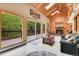 Living room with vaulted ceilings, a fireplace, and access to the deck to enjoy the outdoor views at 11182 S Barney Gulch Rd, Conifer, CO 80433
