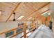 Open loft area with natural wood ceilings, skylights, exposed beams, and views of the outdoor scenery at 11182 S Barney Gulch Rd, Conifer, CO 80433