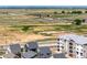 Wide aerial shot showcasing the neighborhood's proximity to major highways and open fields at 17767 E 54Th Ave, Denver, CO 80249