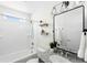 Bright bathroom featuring a bathtub and shower combination, a large mirror, and granite counters at 17767 E 54Th Ave, Denver, CO 80249