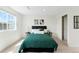 Clean bedroom featuring neutral walls, carpet, a bed, and two windows at 17767 E 54Th Ave, Denver, CO 80249