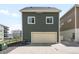 Exterior view of home featuring a two-car garage, light colored siding, and a concrete driveway at 17767 E 54Th Ave, Denver, CO 80249