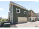 Exterior view of home featuring a two-car garage, light colored siding, and a concrete driveway at 17767 E 54Th Ave, Denver, CO 80249
