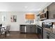 Bright kitchen with stainless steel appliances, gray cabinets, and a subway tile backsplash perfect for cooking at 17767 E 54Th Ave, Denver, CO 80249