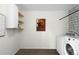 Efficient laundry room with modern appliances, shelving, and stylish decor at 17767 E 54Th Ave, Denver, CO 80249