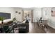 Spacious living room with modern decor, a comfortable sofa, and large windows that offer a bright and airy feel at 17767 E 54Th Ave, Denver, CO 80249