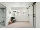 Bright main bedroom with a cozy chair, natural light, and a modern sliding door, creating a peaceful and inviting space at 17767 E 54Th Ave, Denver, CO 80249