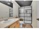 Modern bathroom featuring an updated vanity, walk-in shower with black trim, and a sleek design at 3406 Purcell St, Brighton, CO 80601