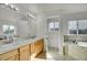 Bright primary bathroom with a double vanity, soaking tub, and separate toilet room for added privacy at 3406 Purcell St, Brighton, CO 80601