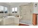 Relaxing bathroom featuring a soaking tub and a glass-enclosed shower for a spa-like experience at 3406 Purcell St, Brighton, CO 80601