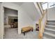 Hallway with staircase, a small shoe rack, and a view into a cozy living area at 3406 Purcell St, Brighton, CO 80601