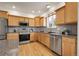 Well-lit kitchen with modern appliances, granite countertops, and stylish cabinetry at 3406 Purcell St, Brighton, CO 80601