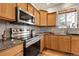 Close-up of a kitchen with stainless steel appliances and light wood cabinets at 3406 Purcell St, Brighton, CO 80601