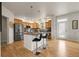 Kitchen featuring a central island with seating and modern appliances at 3406 Purcell St, Brighton, CO 80601