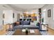 Cozy living room featuring a comfortable sofa, modern decor, and hardwood floors at 3406 Purcell St, Brighton, CO 80601